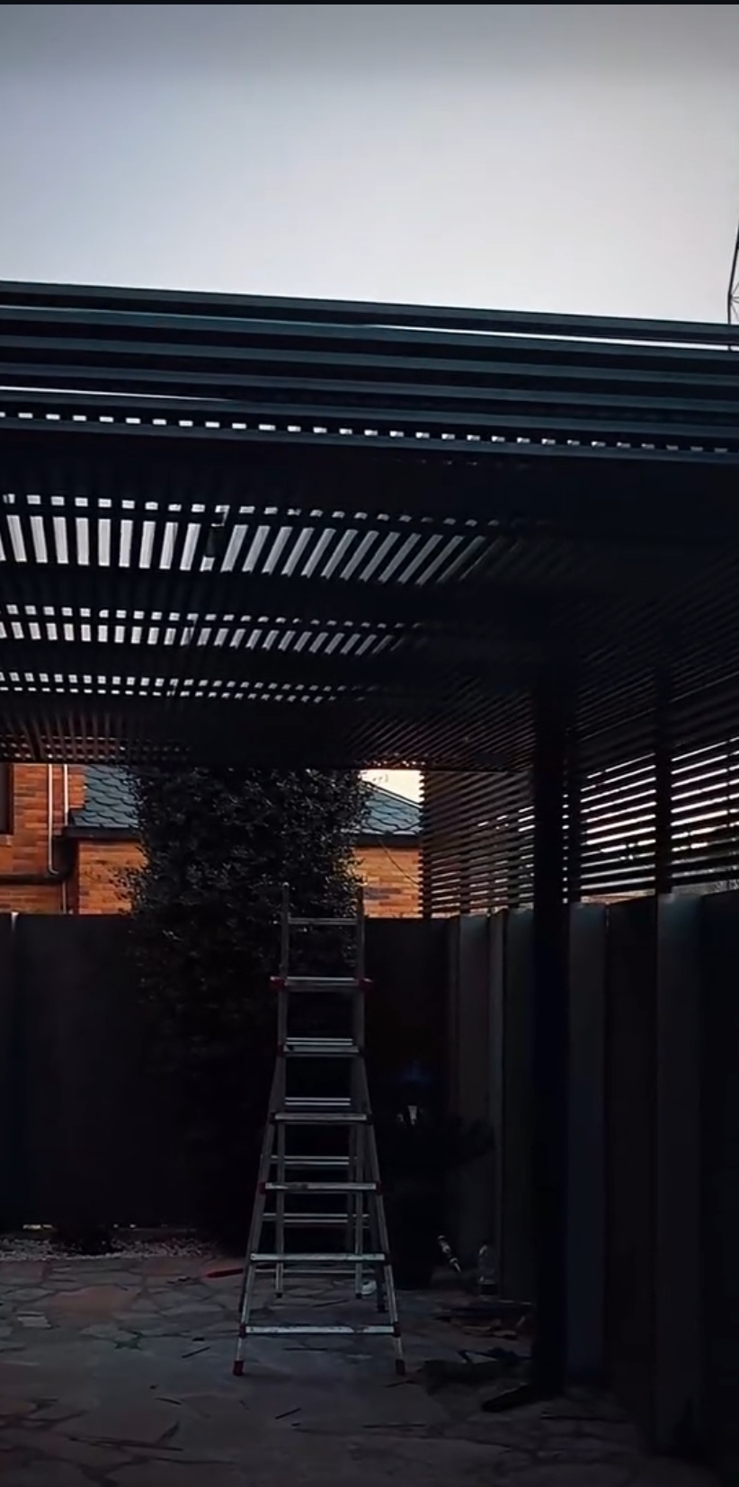 Marquesina metálica - Perspectiva lateral mostrando anclaje a muro y pilares frontales